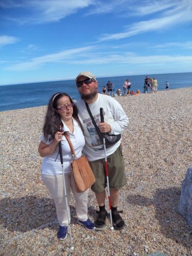 Tony and Tatiana on rocky Slapton Sands Beach. View out to sea behind.